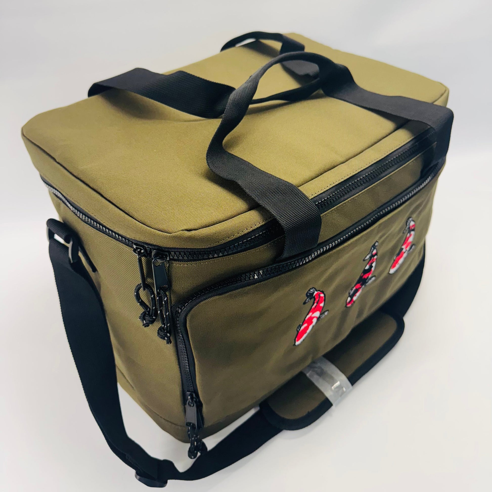 Green bag with black straps on a white background