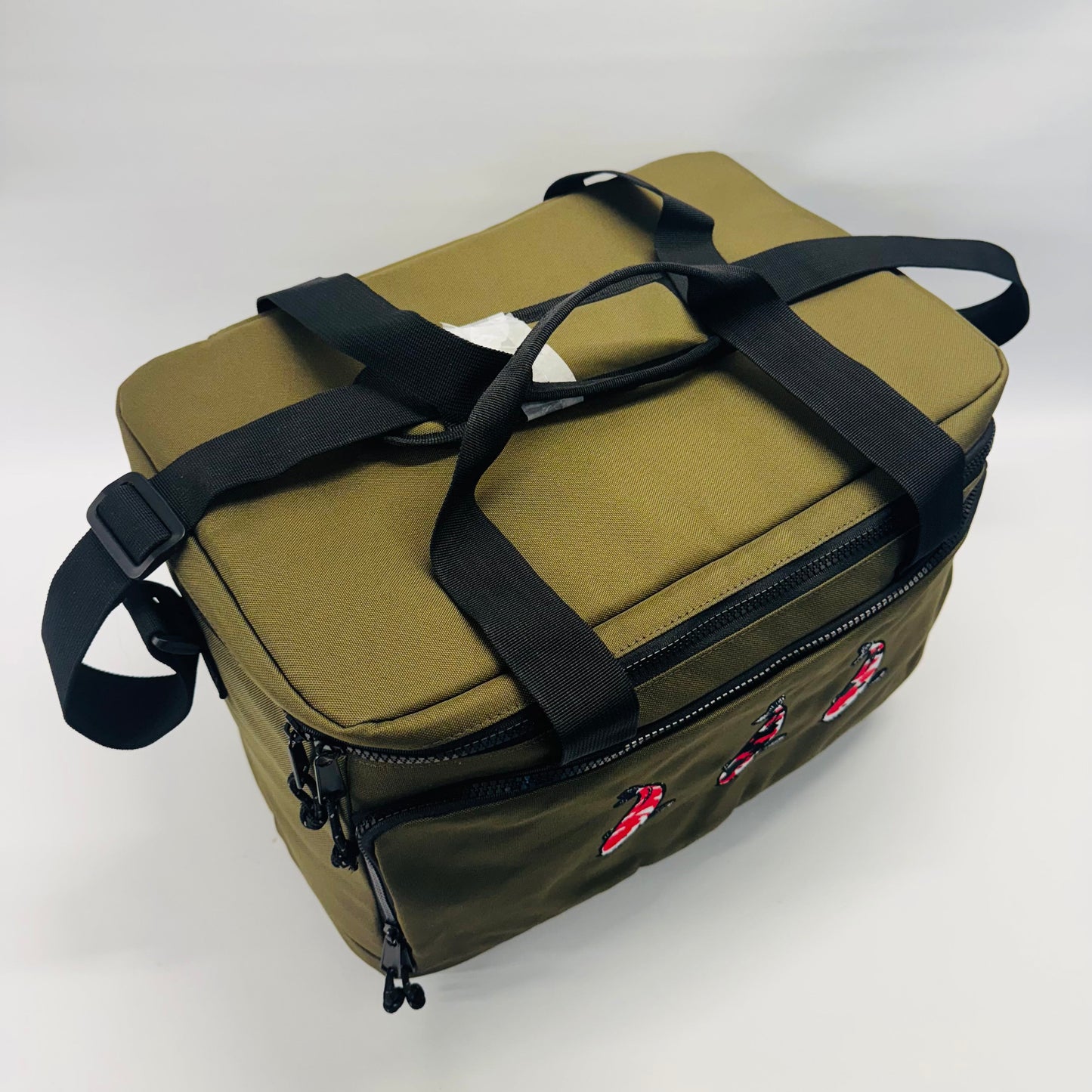 Green bag with black straps on a white background